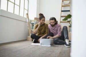 Orlando Home Inspection man and woman sitting on a floor searching something with their laptop